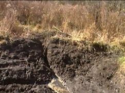 Close up of tiny hand dug slit in secondary dam