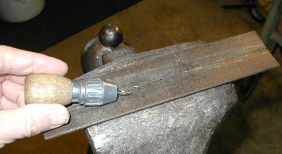 Chest rivet making fixture in Vise